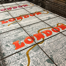 Load image into Gallery viewer, A close-up of a screen-printed London map with large orange 'LONDON' lettering and a gold River Thames.