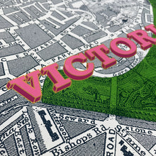Load image into Gallery viewer, A stylised close-up of a vintage Victoria Park map with the word "VICTORIA PARK" overlaid in large pink 3D letters over a green highlighted area.