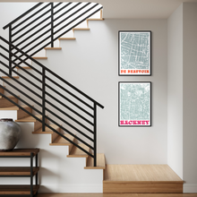 Load image into Gallery viewer, Two framed vintage-style street map prints hanging on a white wall in a modern interior setting with a wooden staircase and black metal railing.