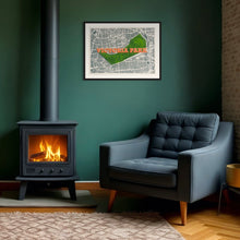 Load image into Gallery viewer, Framed Victoria Park London map screen print wall art in a contemporary interior with modernist chair and fireplace

