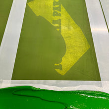 Load image into Gallery viewer, A close-up of a screen-printed Victoria Park, and a thick band of bright green ink along the bottom edge.
